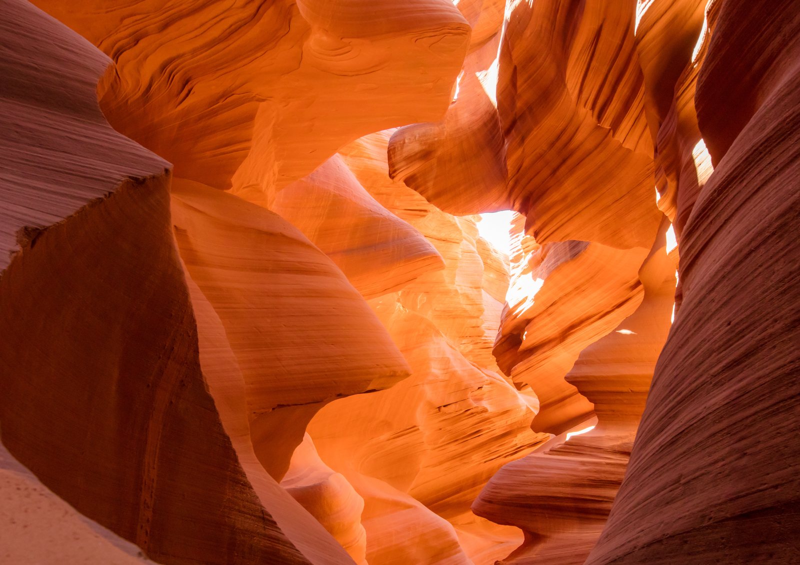 Orange light pouring through a slot canyon